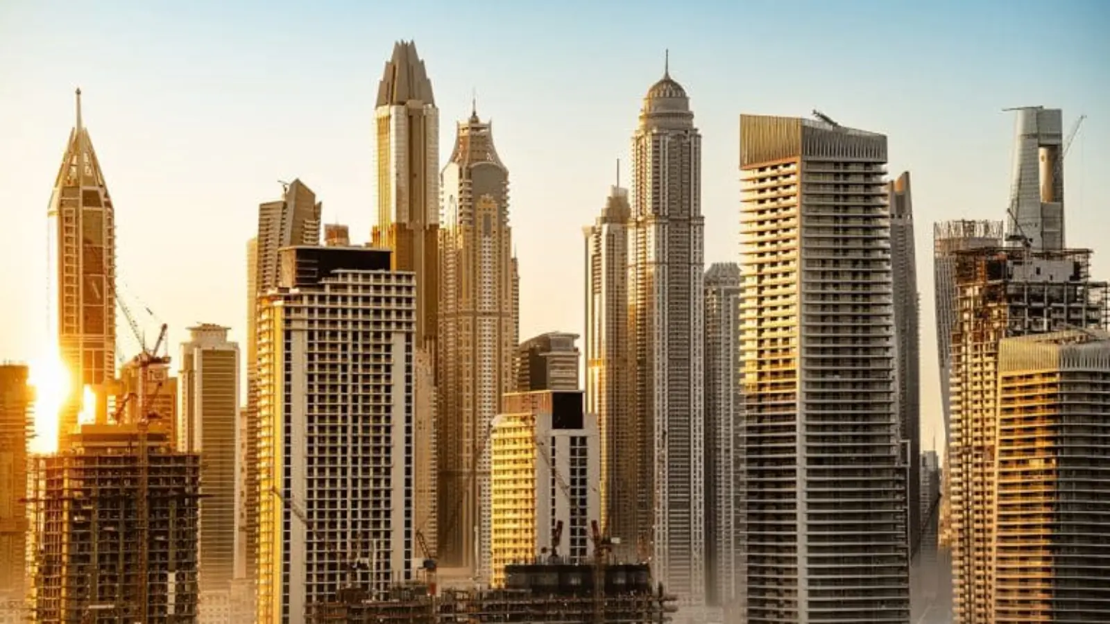 Modern skyscrapers against sunset sky